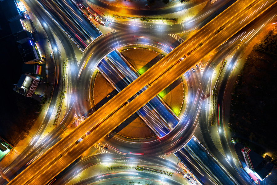 Aerial view of traffic in roundabout and highway at night. Aerial view of traffic in roundabout and highway at night.
